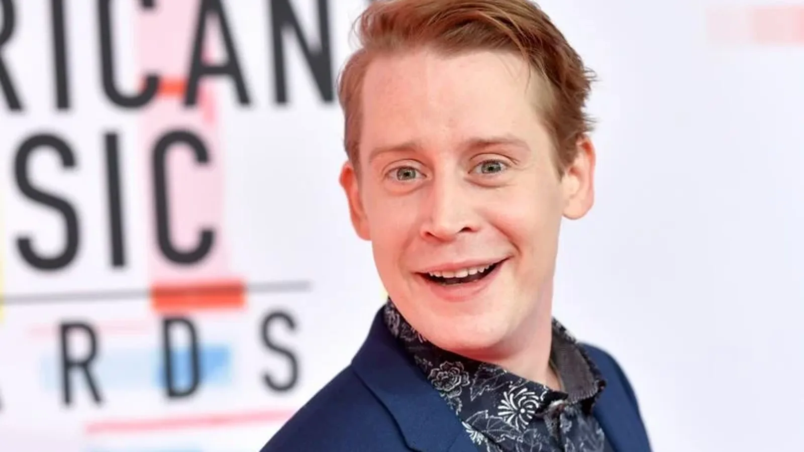 Macaulay Culkin smiling at an awards event