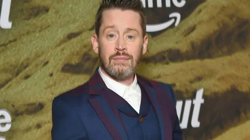 Macaulay Culkin attending a premiere event in a blue suit